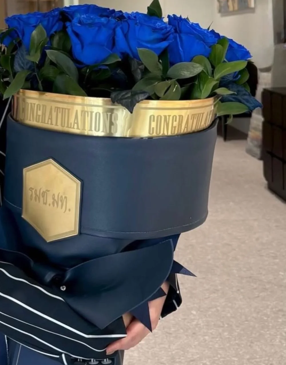 Royal blue roses in a navy leather box with an engraved gold plaque